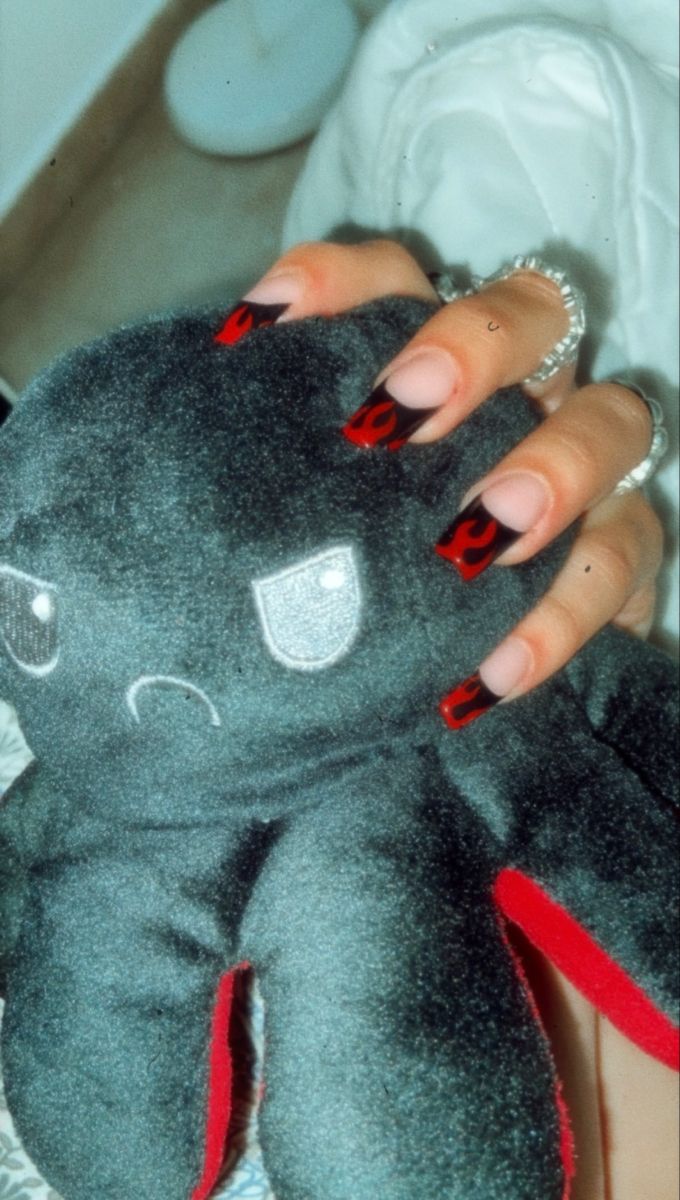 Bold Black and Red Nail Design with Flame Patterns and Playful Octopus Accents.