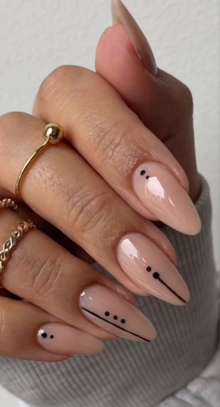 Elegant Nude Nail Design with Minimal Black Accents and Glossy Finish.