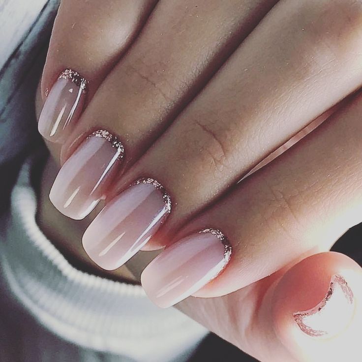 Sophisticated Ombre Nails with Sparkling Rose Gold Tips and Chic Crescent Accent.