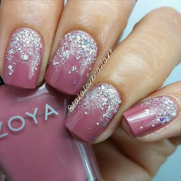 Elegant Sparkling Ombre Nail Design: Dusty Rose Base with Silver and Holographic Glitter Transition.