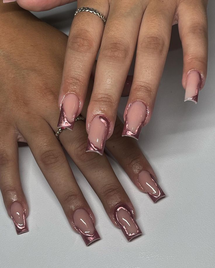 Sophisticated Rose Gold and Nude Marble Nail Design with Glossy Pointed Tips.