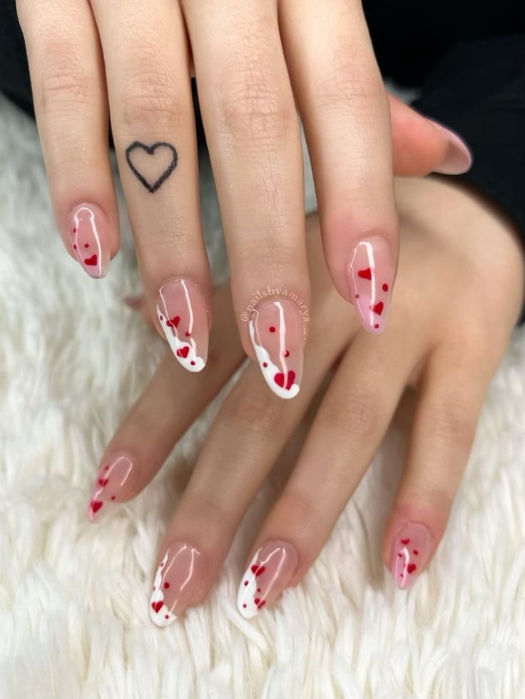 Chic Nude Nail Design with Whimsical White Tips and Romantic Red Heart Accents