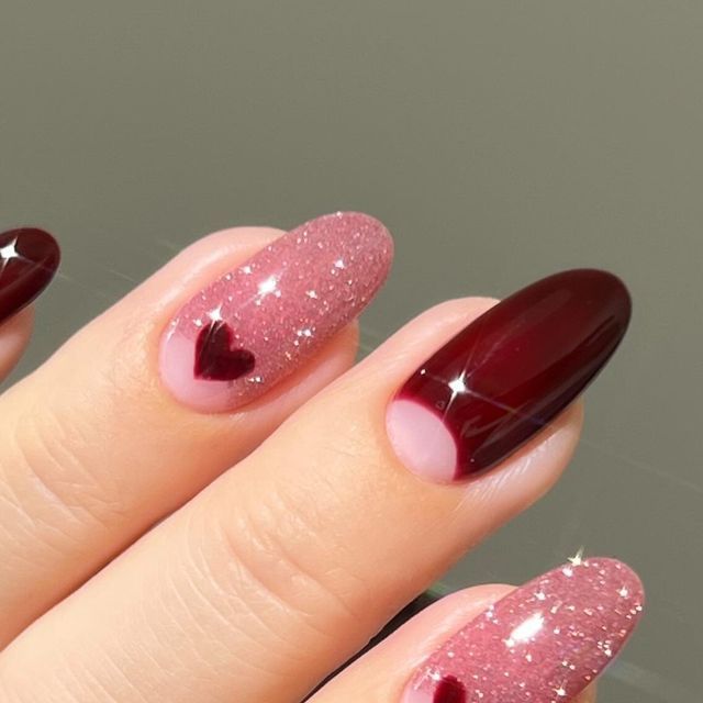 Charming Burgundy and Pink Nail Design with Heart Motif for a Stylish Look.