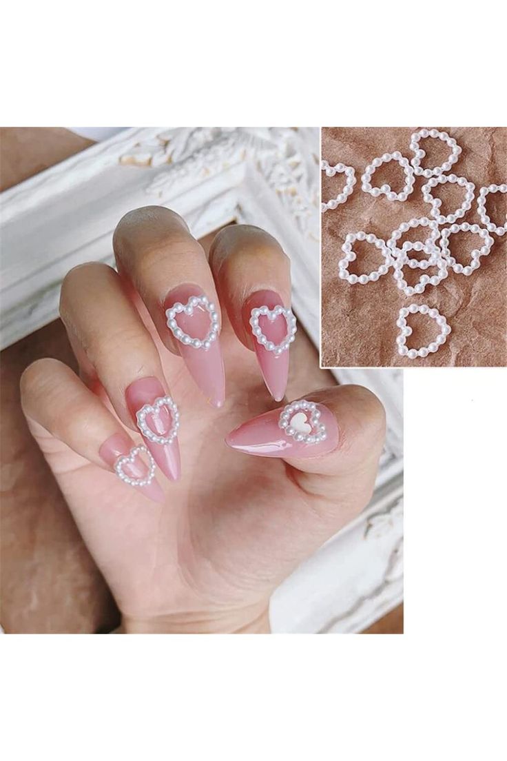 Charming Soft Pink Nail Design with Heart Accents and Pearl Details.