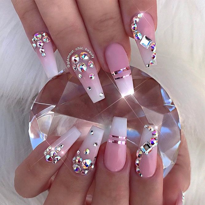 Elegant Pink and White Nail Design with Rhinestones and Metallic Accents for Special Occasions.