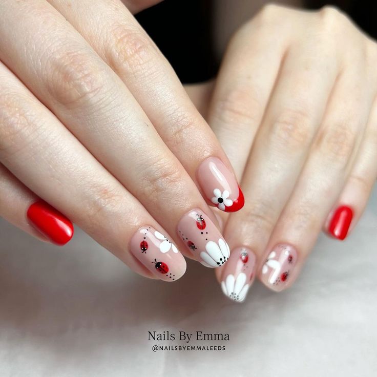 Playful Ladybug and Daisy Nail Design: A Cheerful Blend of Red and Nude Shades.