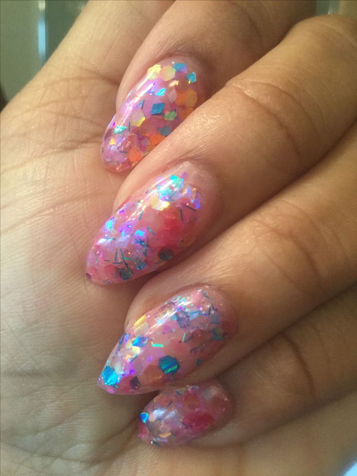 Translucent Pink Glitter Nail Design with Holographic Confetti Flakes: A Sparkling Blend of Elegance and Fun.