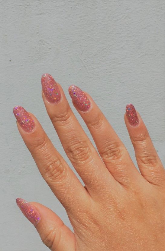 Chic Pink Gradient Nail Design with Glitter and Almond Tips.