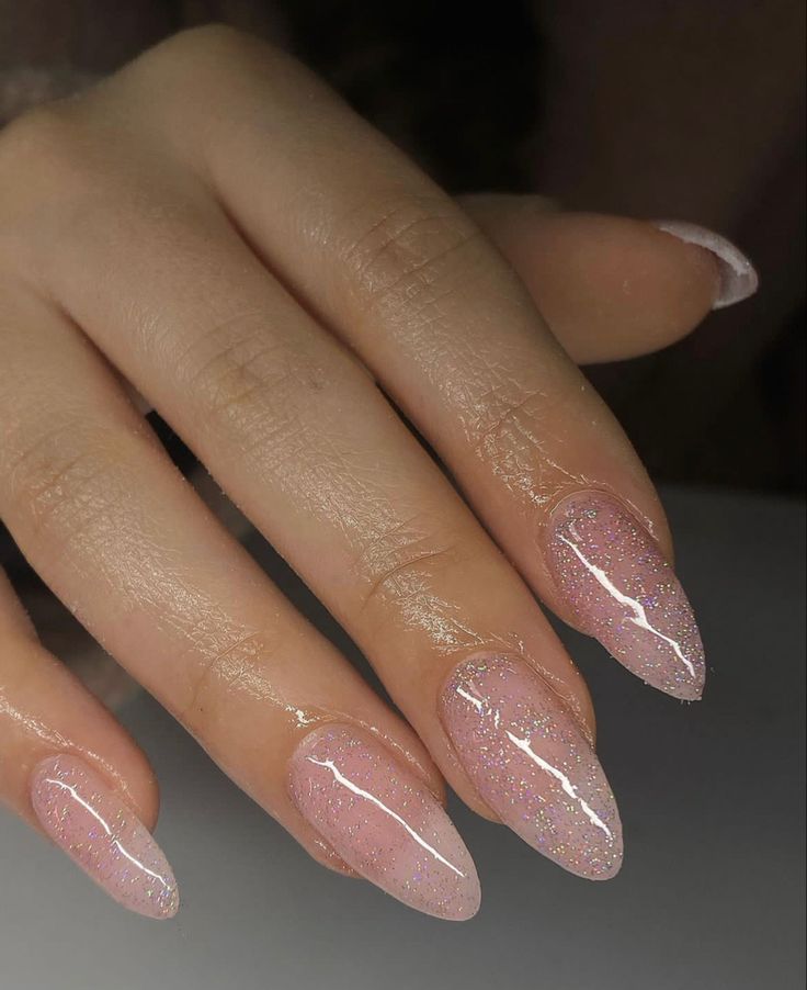 Stunning Almond-Shaped Nail Design with Soft Pink and Glitter Accents