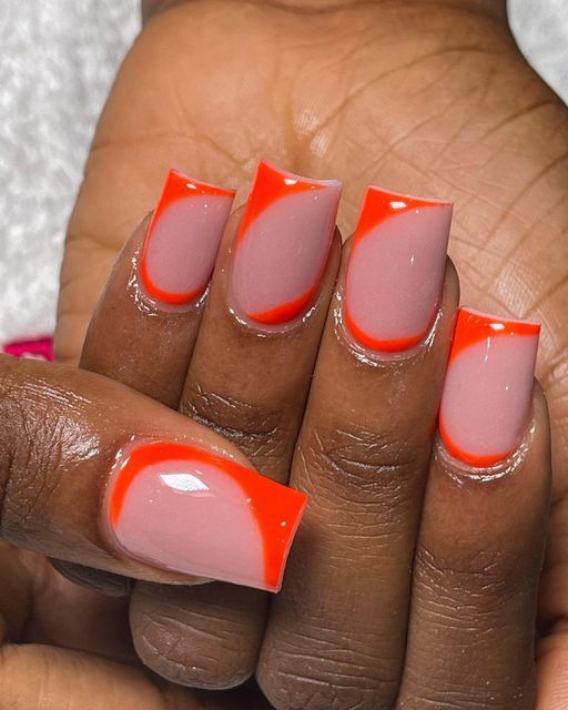 Striking Bold Nail Design: Elegant Nude with Vibrant Orange Accents