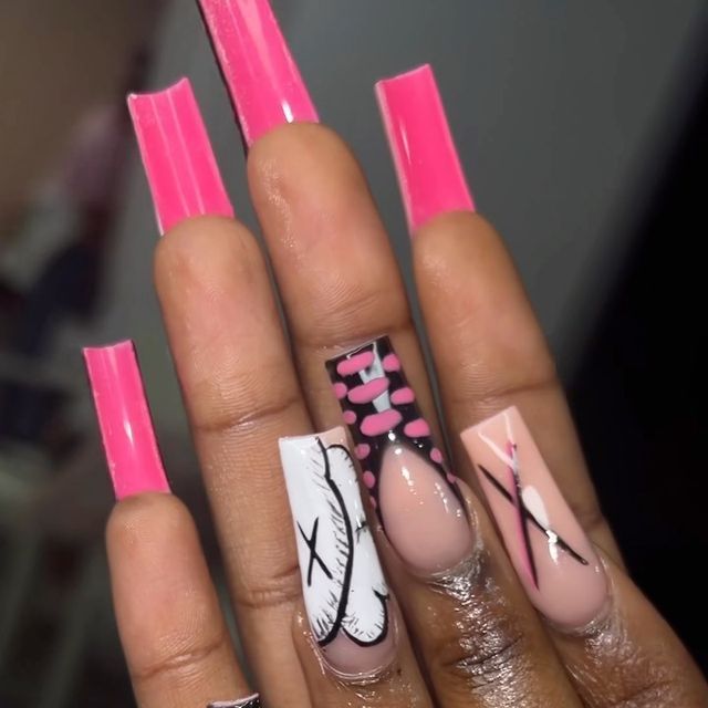 Vibrant Pink and Nude Stiletto Nails with Bold Patterns and Glossy Finishes.