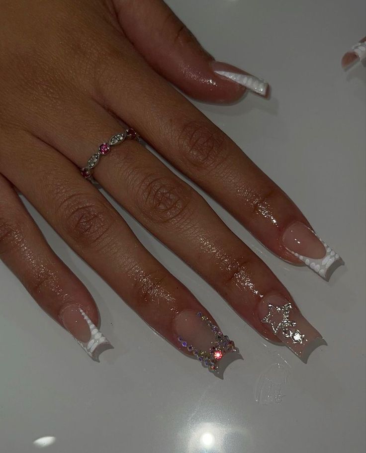 Chic Long Acrylic French Manicure with Glamorous Silver Accents and Colorful Rhinestones.