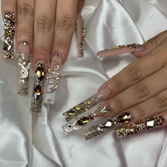 Elegant Rhinestone-Embellished Nail Design with Elongated Tips and Shimmering Accents