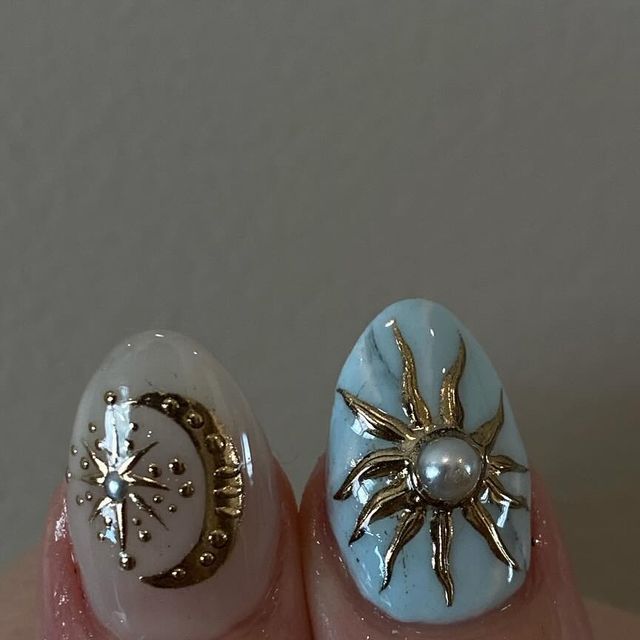 Celestial-Inspired Elegant Nail Design with Moon and Sun Motifs