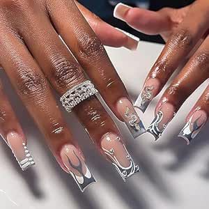 Elegant Nude and Silver Nail Design with Intricate Patterns and Statement Ring.