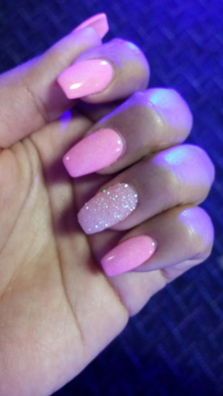 Elegant Pink Nail Design with Glossy Finish and Glitter Accent for a Feminine Touch.