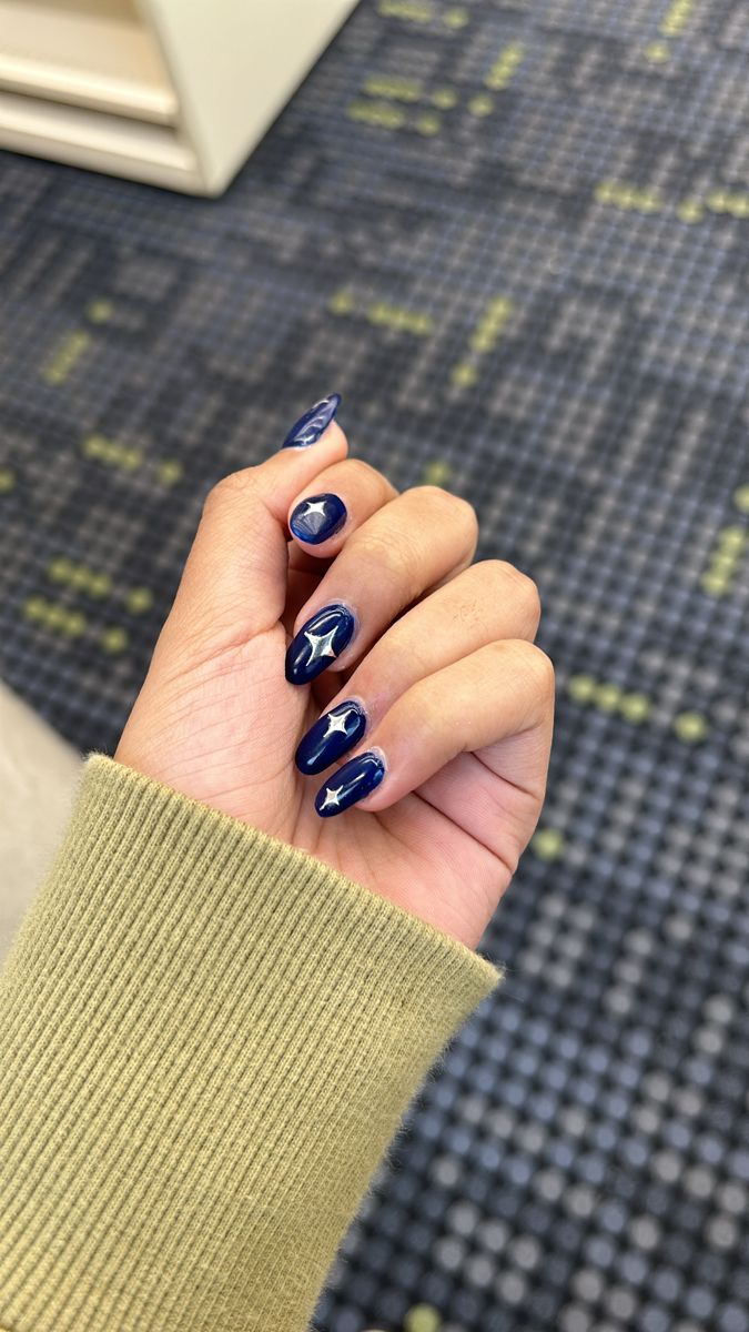 Celestial-Inspired Deep Navy Blue Nails with Star Accents: Elegance Meets Creativity.