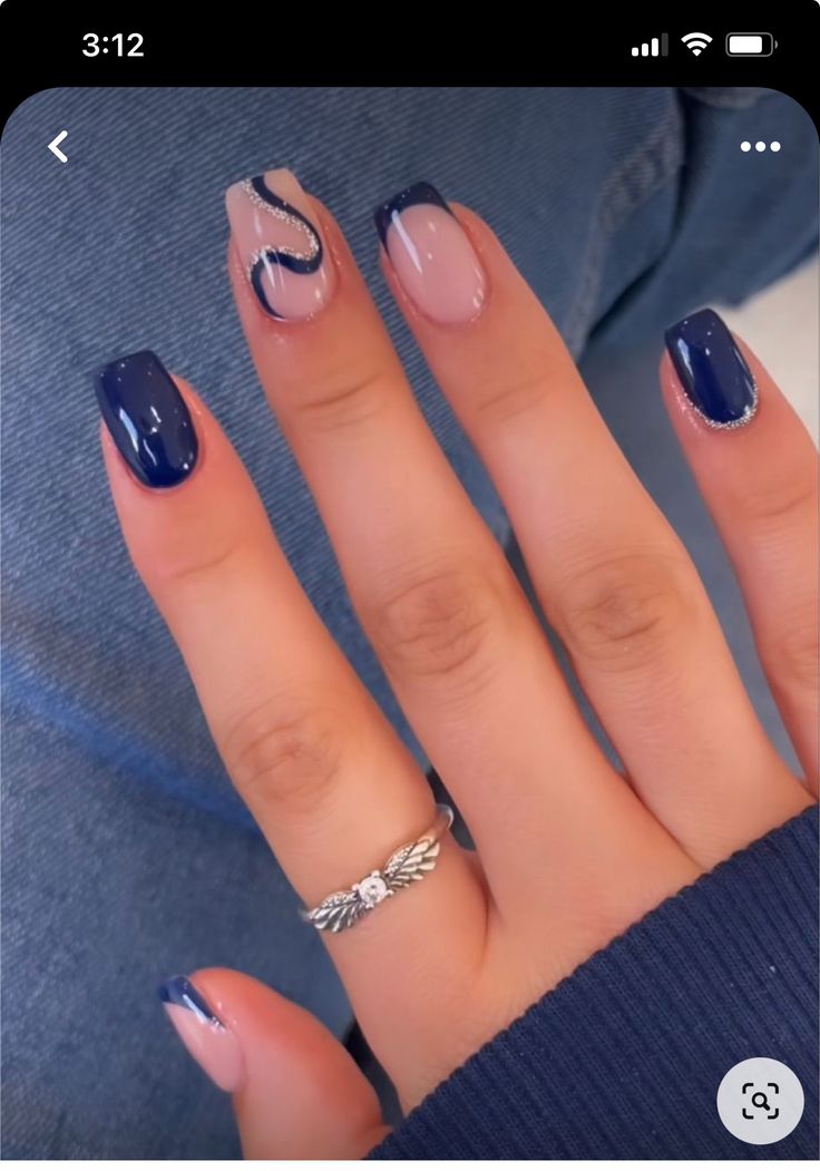 Elegant Nail Design with Deep Navy and Soft Nude Hues Featuring Unique Wave Patterns and Glossy Finishes.