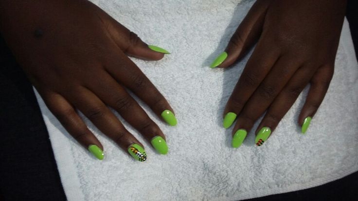 Vibrant Green Glossy Nail Design with Intricate Accents for a Stylish Look.