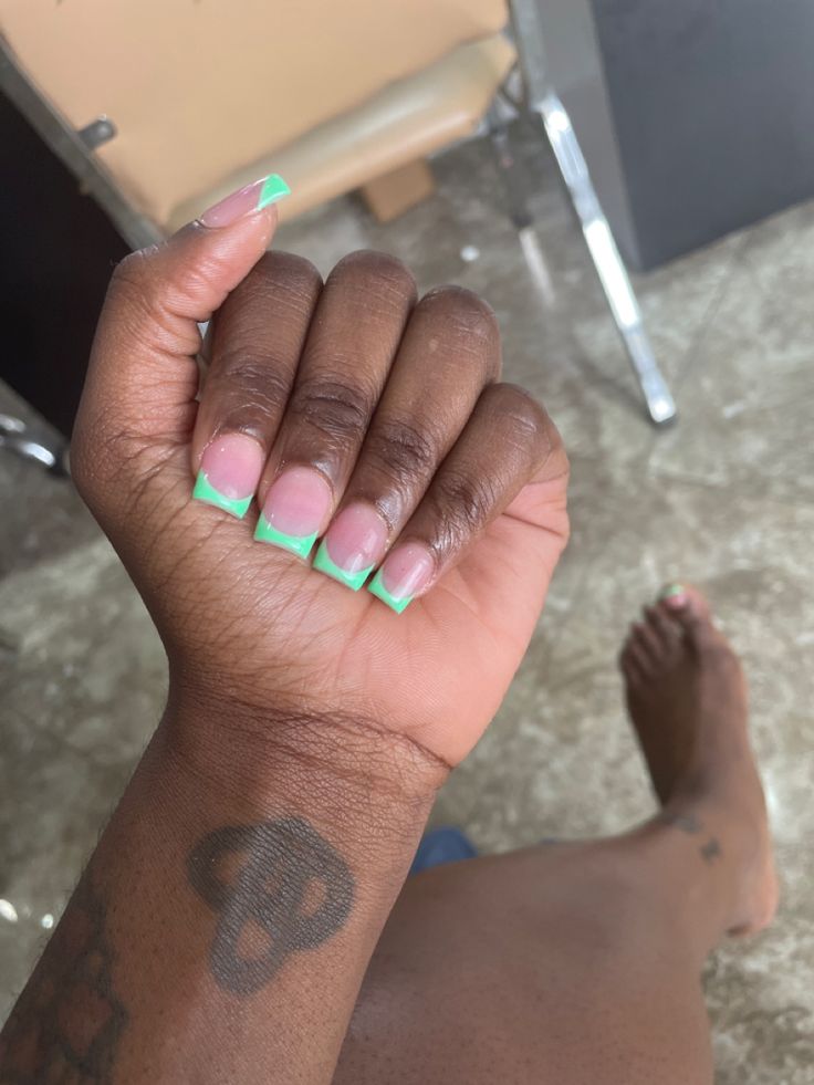 Playful and Chic: Modern Nail Design with Light Pink Base and Vibrant Green Tips.