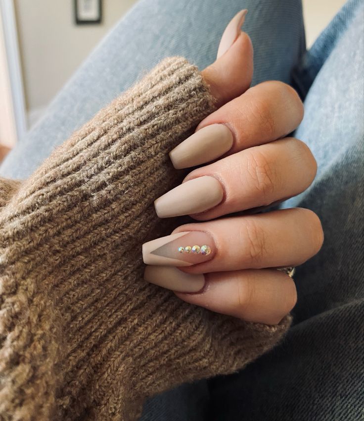 Elegant Matte Nude Nails with Gem Accent for a Chic, Cozy Look.