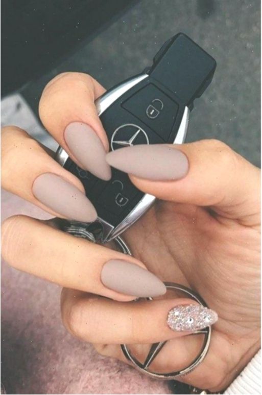 Elegant Matte Taupe Nails with Glitter Accents for Versatile Chic Style.