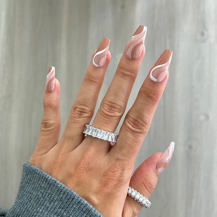 Sophisticated Nude Nail Design with Striking White Swirls and Delicate Accents