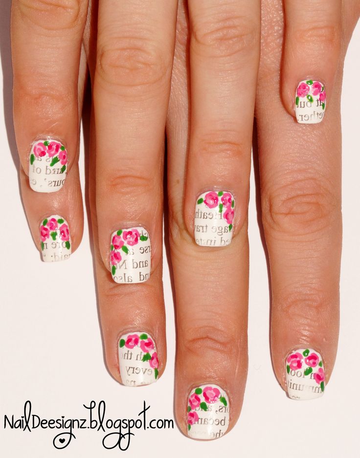 Charming Floral Nail Design with Pink Roses and Whimsical Text on a White Background.