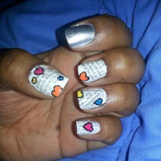 Whimsical Nail Design: Silver Polish and Newspaper Print with Colorful Heart Accents