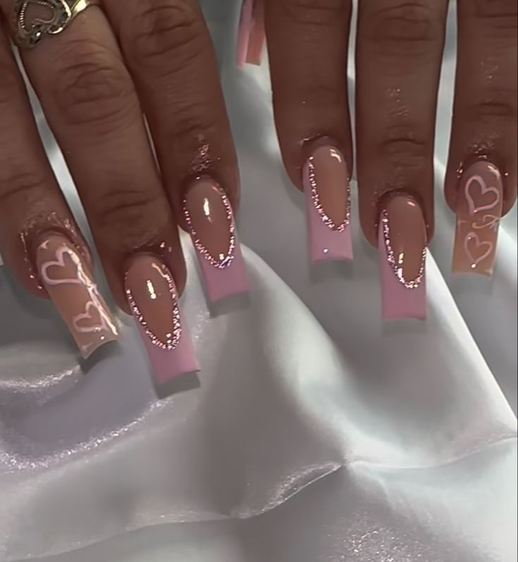 Chic Soft Pink Ombre Nail Design with Intricate Heart Patterns