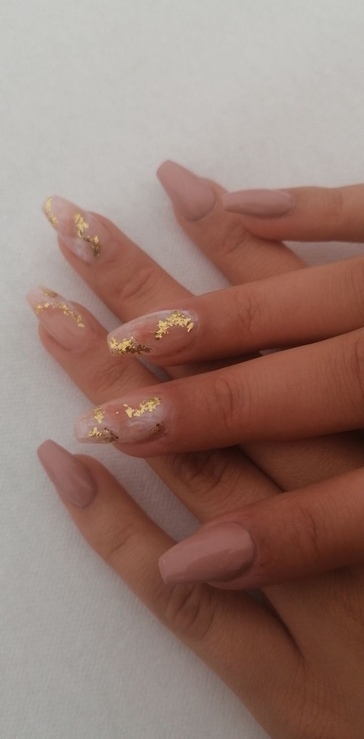 Sophisticated Nude Nail Design with Glossy Finishes and Gold Foil Accents