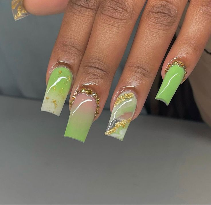 Chic Gradient Green Nail Design with Gold Accents and Marble Patterns.