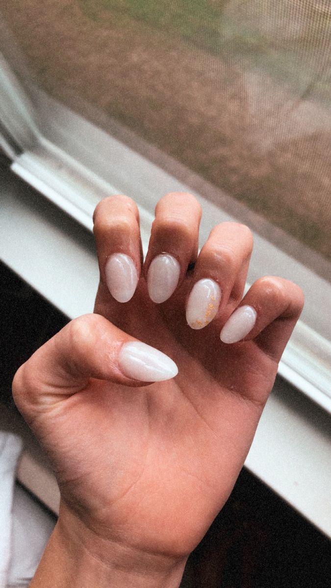 Elegant Pastel Almond Nail Design with Delicate Shimmer and Unique Accent.