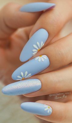 Chic Blue Matte Nails with Whimsical Daisy Designs and Soft Shimmer