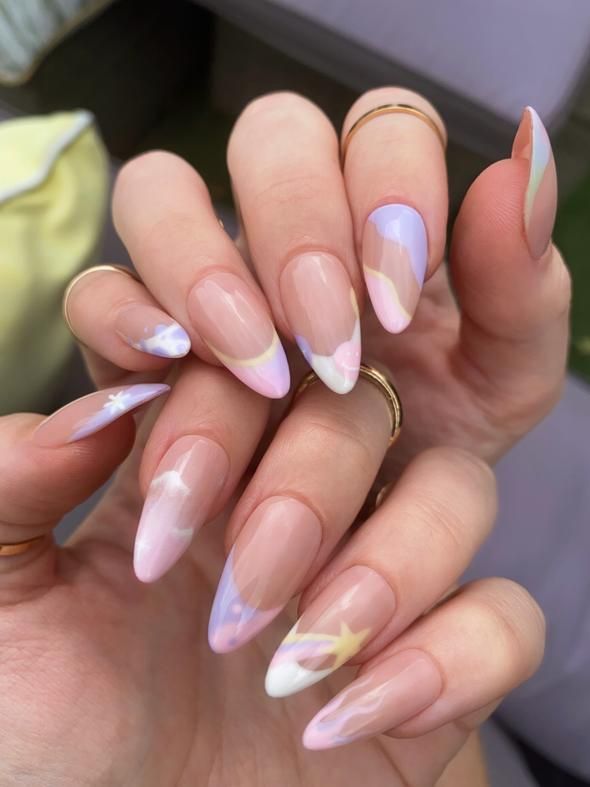 Whimsical Pastel Almond Nail Design with Celestial Patterns.