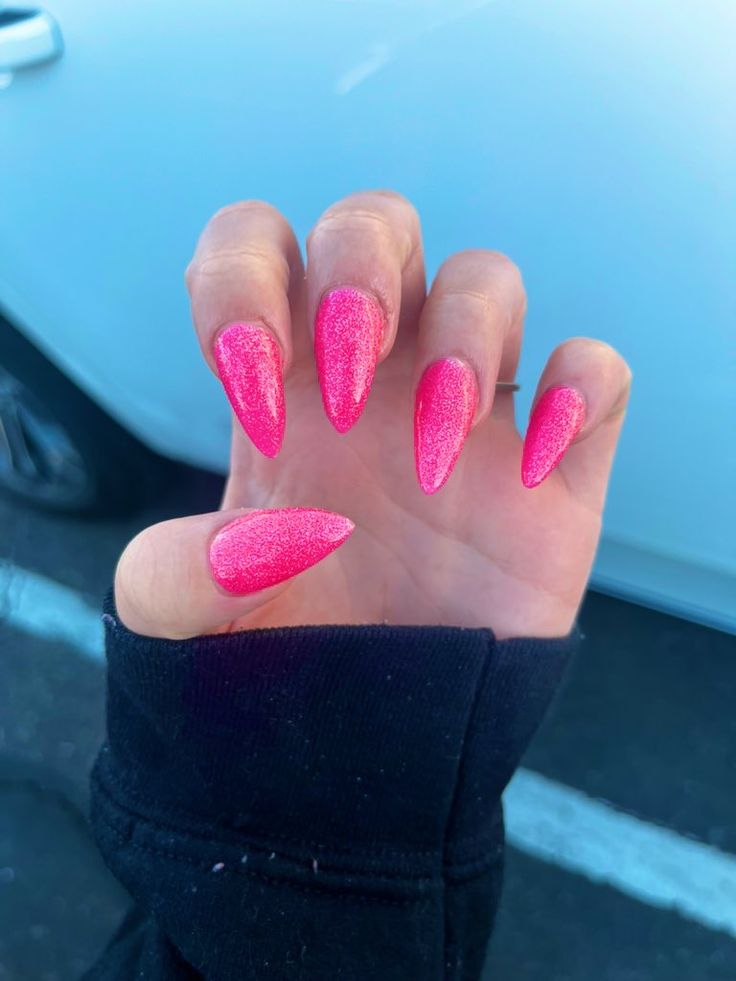 Bold Glittery Pink Stiletto Nails: A Striking Statement of Elegance and Fun