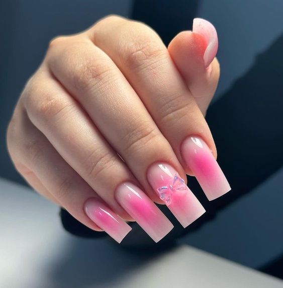 Elegant Ombre Nail Design with Soft Pink Gradients and Butterfly Accent for a Playful Touch.