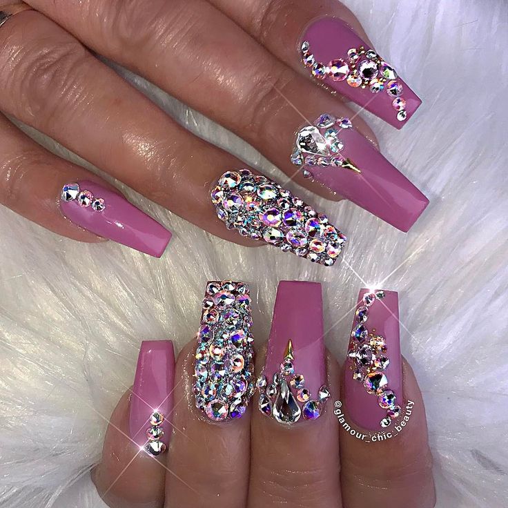 Glamorous Nail Art: Soft Pink and Sparkling Rhinestones on Long Acrylics.