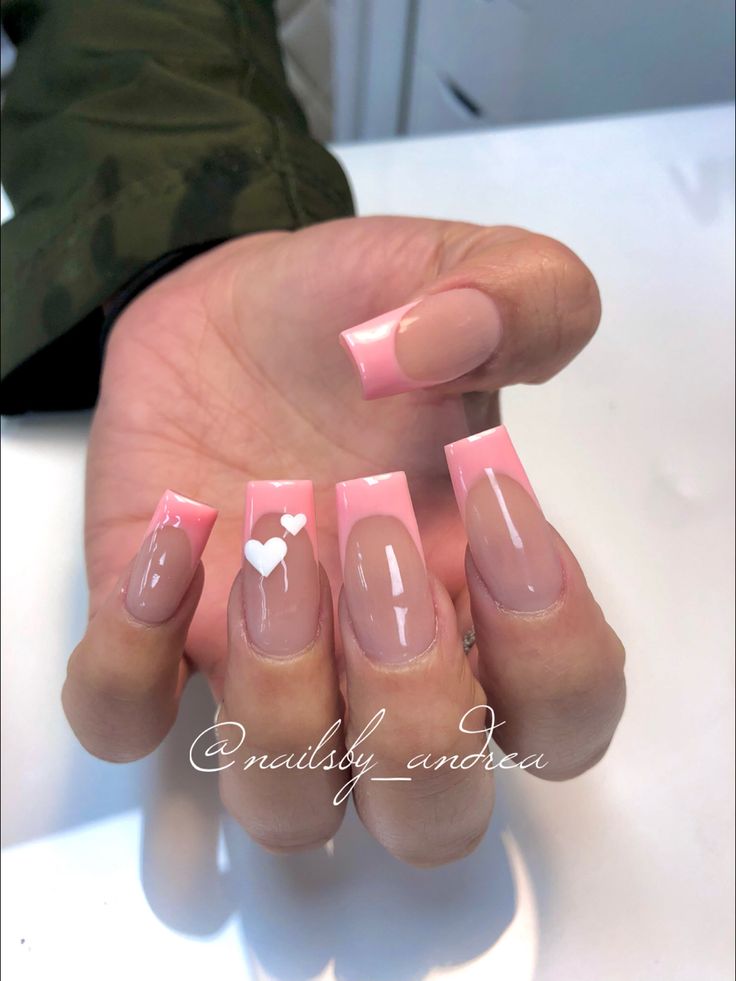 Chic Soft Pink and Nude Nail Design with Elegant Squared Tips and Playful Heart Accent.