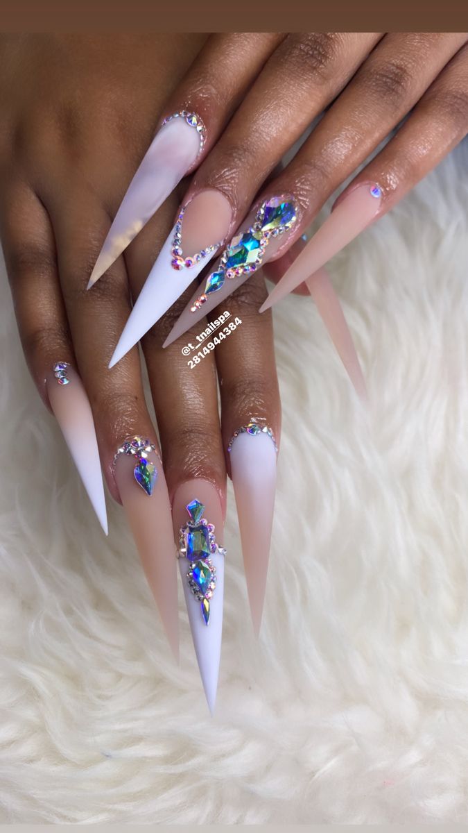 Elegant Gradient Stiletto Nails Adorned with Iridescent Gems for Dazzling Style.