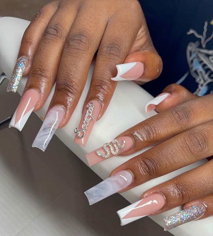 Chic Nail Design: Elegant Modern Blend with Glossy Nude, Vibrant White Tips, Marble Effects, and Sparkling Embellishments.