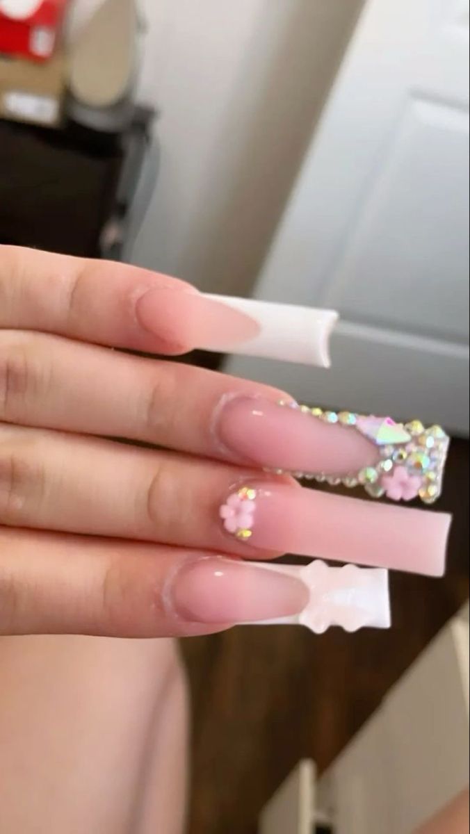 Elegant Ombre Nail Design with Playful Rhinestones and Floral Accents