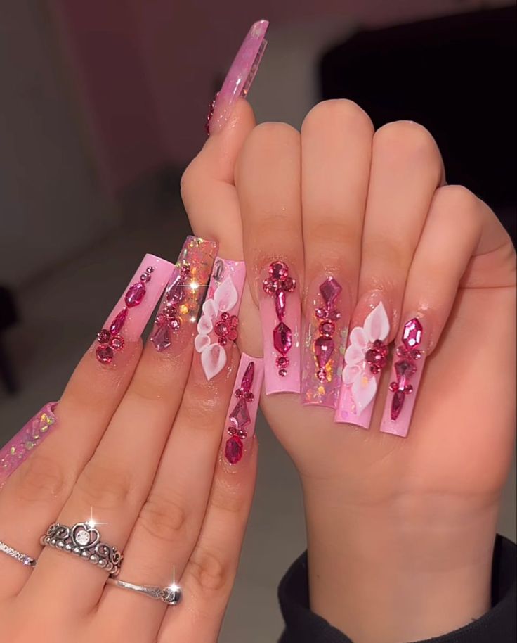 Elegant Pink Floral Nail Art with Glamorous Gem Embellishments.