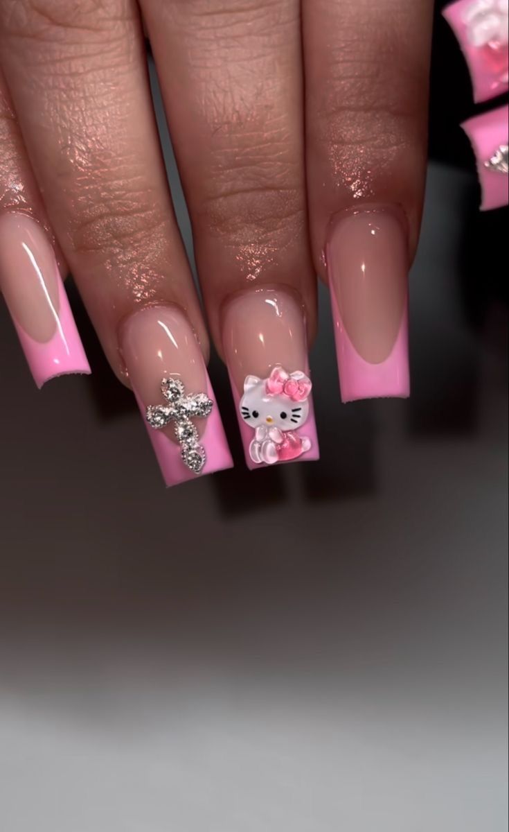 Elegant Pink-Tipped Nail Design with Playful Embellishments for Sophisticated Style.