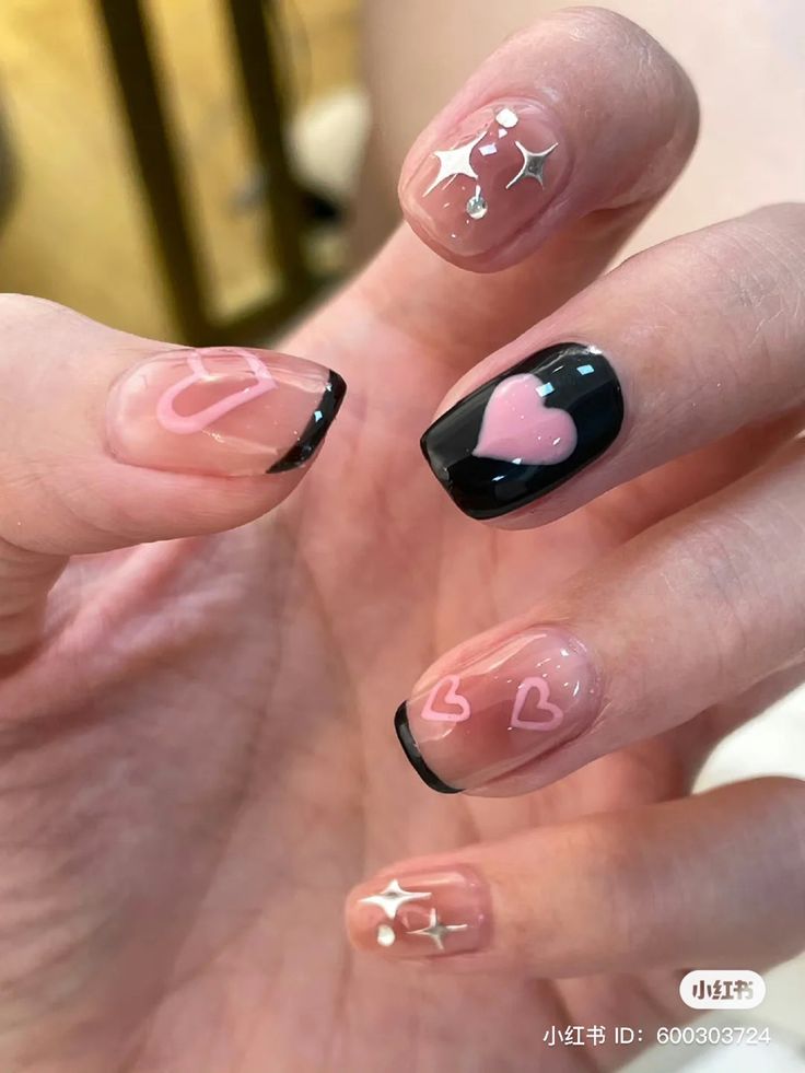 Chic and Playful Nail Design with Heart Motifs and Sparkling Accents.