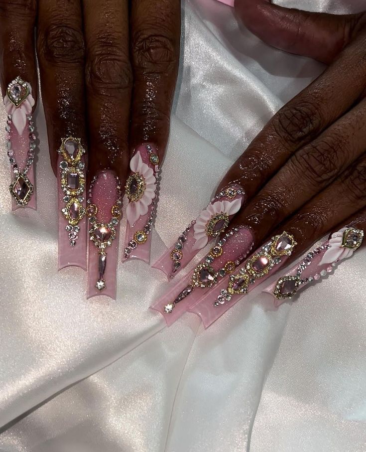 Luxurious Floral-Inspired Elongated Nail Design with Gems and Soft Pink Palette.