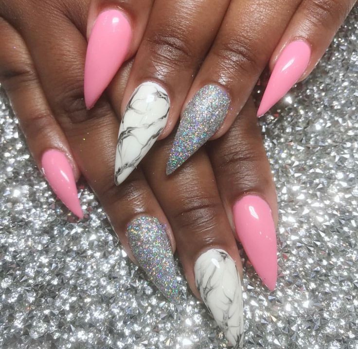 Bold and Playful Stiletto Nails: Vibrant Pink, Silver Glitter, and Elegant White Marble Accents.