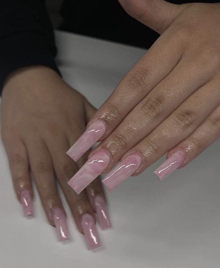 Sophisticated Soft Pink Acrylic Nails with Intricate Marble Patterns for Glamorous Elegance.