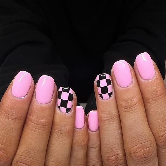 Chic Pink Nail Design with Glossy Finish and Playful Checkerboard Accent.