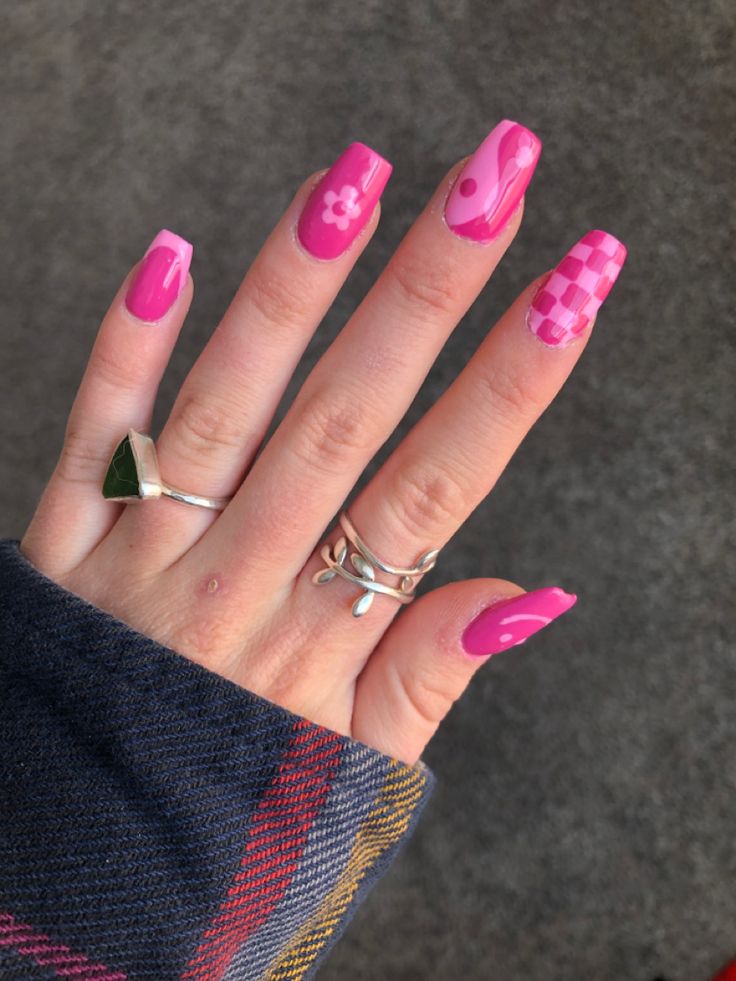 Vibrant Pink Checkerboard and Floral Nail Art: A Trendy Expression of Personal Style.